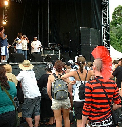 from Punk to Polynesian. NZ's Nesian Mystik on stage, Chazz from NZ's The Rabble in audience. Big Day Out Auckland, New Zealand. 19 January 2007